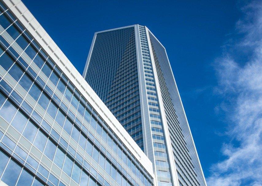 Tall glass skyscraper against a blue sky