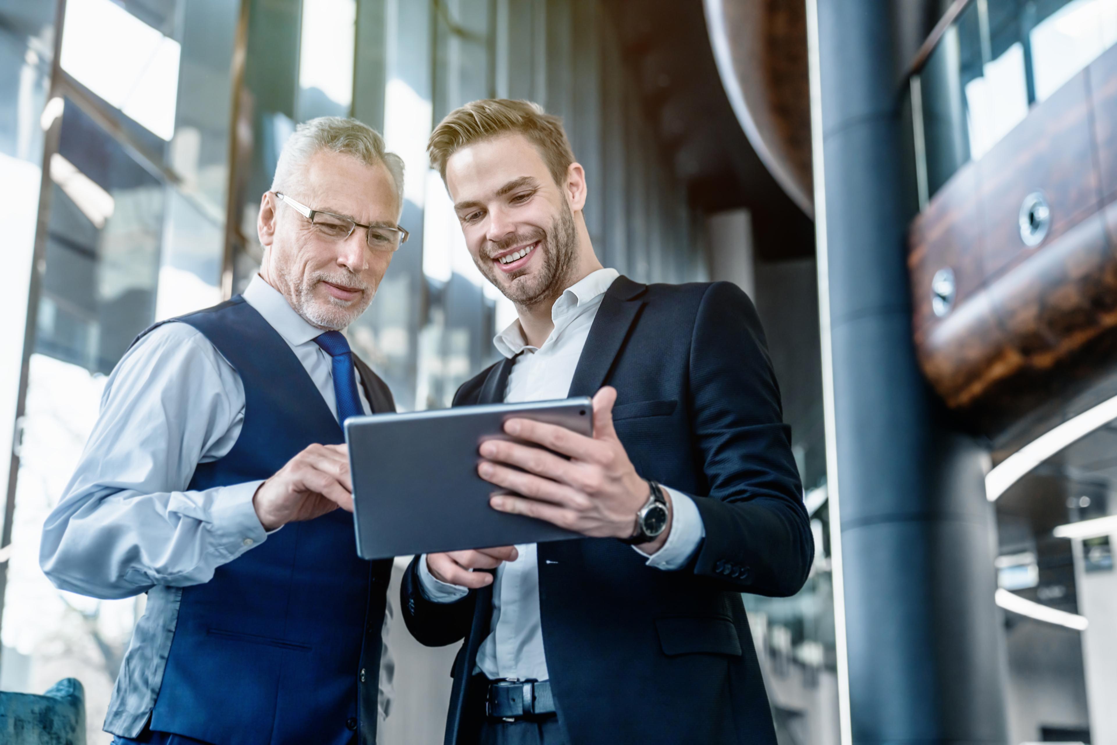 Two business professionals looking at a tablet